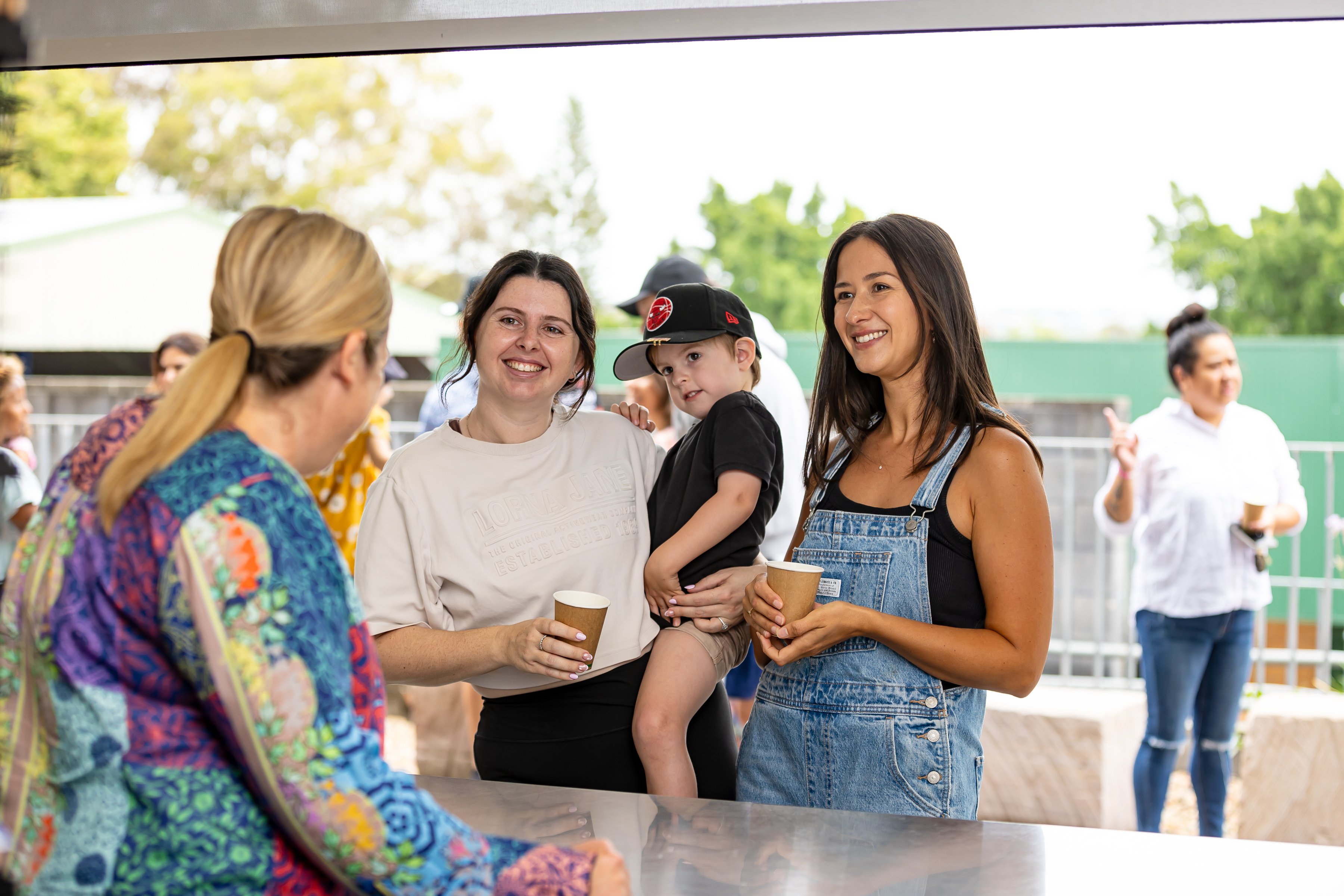 Picture of parents standing around the Tuckshop mingling at Sr Jenny's Cuppa